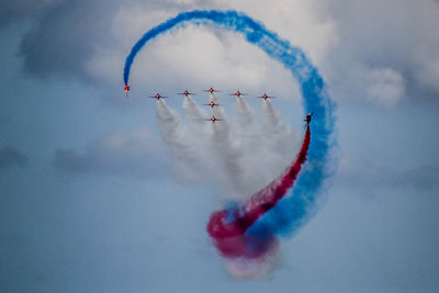 Low angle view of airshow against sky