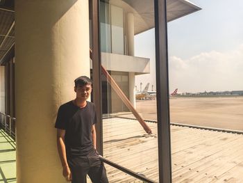 Full length of young man standing against sky