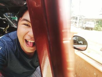 Close-up portrait of smiling woman in car