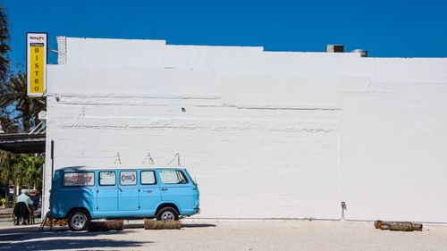 Graffiti on wall of building against blue sky