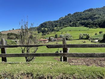 Fence on field against clear sky