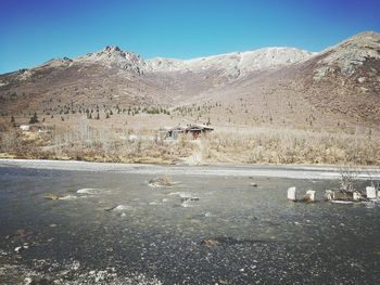 Scenic view of desert against clear blue sky