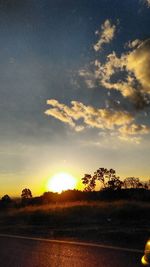 Scenic view of field against sky during sunset