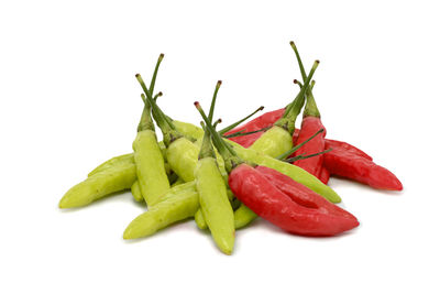 Close-up of chili peppers against white background