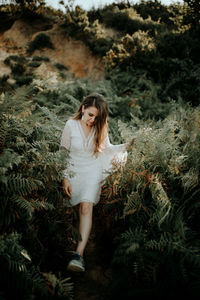 Portrait of beautiful young woman lying on land