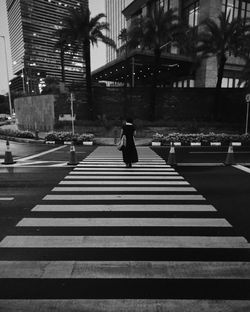 Young lady crossing the street at the business district