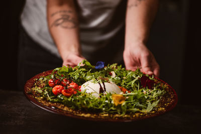 Midsection of man preparing food on table