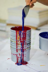 Cropped hand of person mixing paint