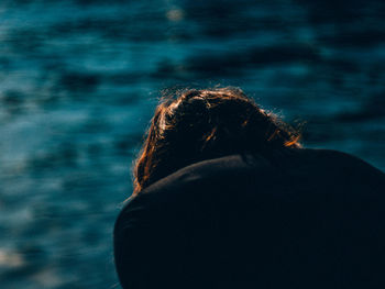 Rear view of woman by sea