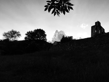 Low angle view of silhouette building against sky