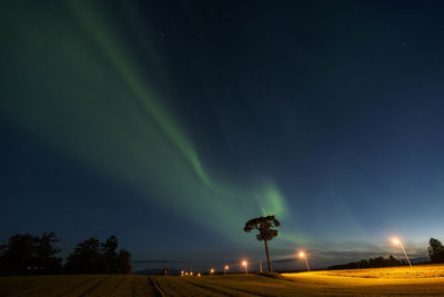 Low angle view of aurora borealis against sky at night