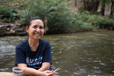 Portrait of a smiling woman in river