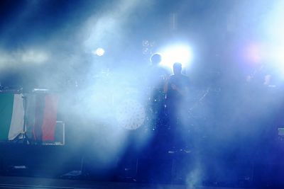 People in illuminated concert at night