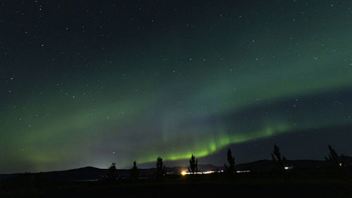 Low angle view of silhouette landscape against sky at night