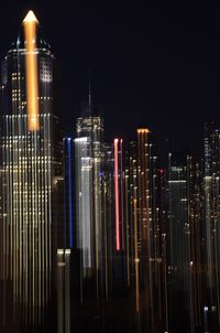 View of skyscrapers lit up at night