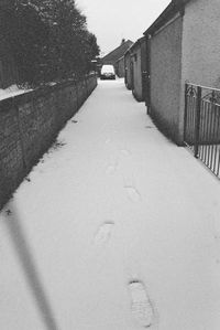 Road amidst buildings in city during winter