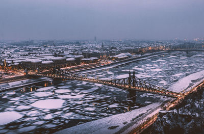 Aerial view of bridge in city during winter