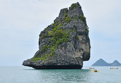 Scenic view of rock in sea against clear sky