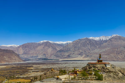 Scenic view of mountains against clear blue sky