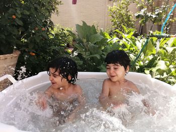 High angle view of kids playing in bathtub outdoors