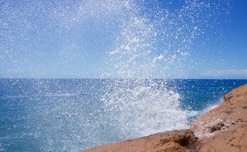 Scenic view of beach against blue sky