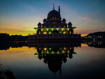 Reflection of building in water at sunset