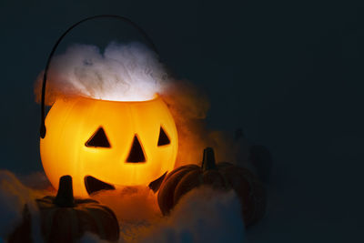 Close-up of illuminated pumpkin against black background