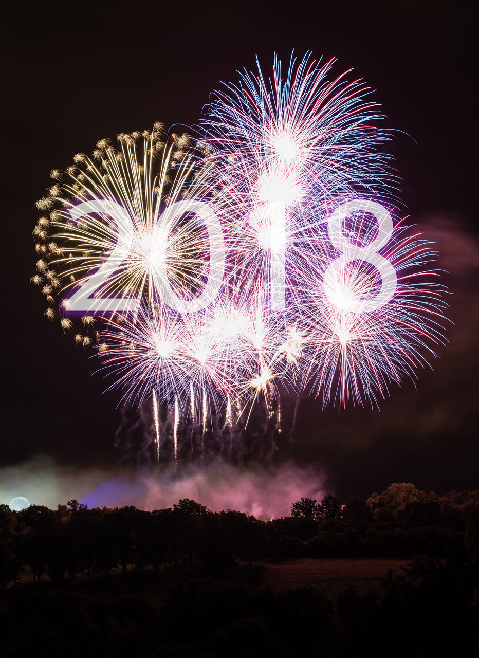 LOW ANGLE VIEW OF FIREWORKS DISPLAY AT NIGHT