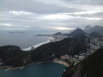 High angle view of sea and mountains against sky