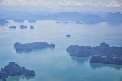 Scenic view of rocks in sea against sky