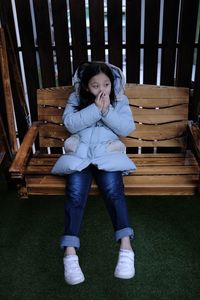 Low section of girl sitting on chair