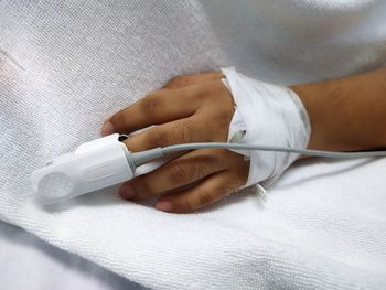 Midsection of doctor holding thermometer