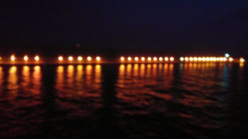 Silhouette of illuminated beach at night