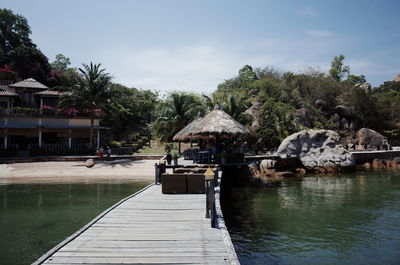 View of swimming pool by lake against sky