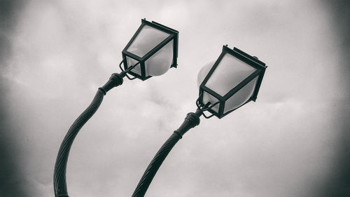 Low angle view of street lights against sky