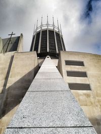 Low angle view of building against cloudy sky