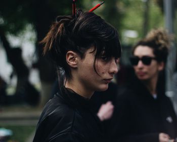 Side view of young woman looking away outdoors