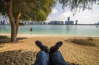 Low section of person relaxing on beach