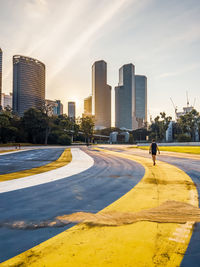 Rear view of man walking on road