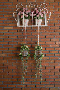 Potted plant against brick wall