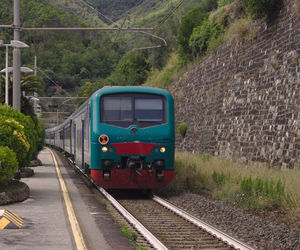 The five lands train is coming at the railstation of moneglia, italy. summer 2019.