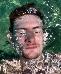 Portrait of young woman in water