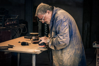 Senior man working in workshop