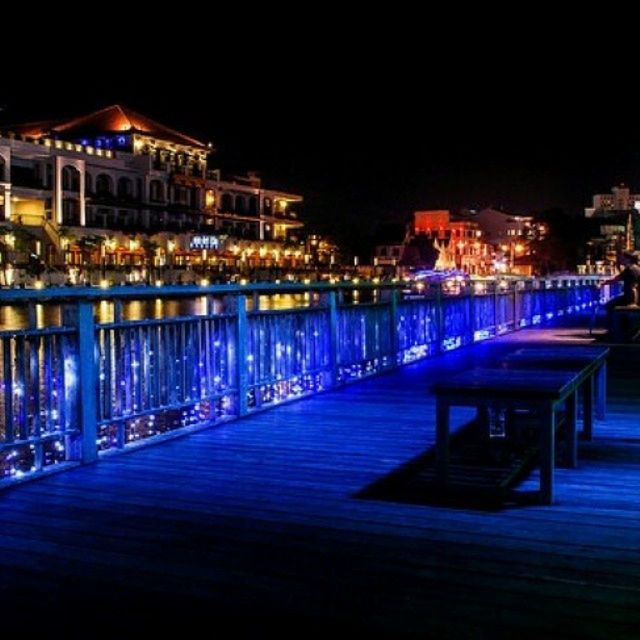 illuminated, night, architecture, built structure, building exterior, water, city, street light, lighting equipment, river, reflection, waterfront, sky, light - natural phenomenon, sea, city life, railing, clear sky, outdoors, light