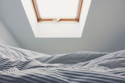 Close-up of curtain on bed at home