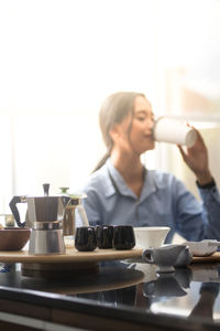 Woman drinking coffee at home