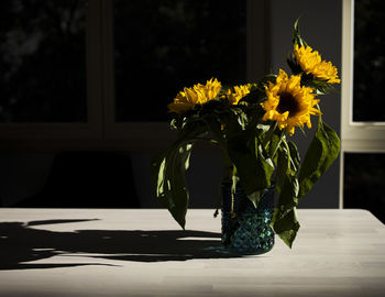 Close-up of yellow flower vase on table