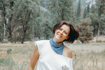 Portrait of smiling middle aged woman on nature background.