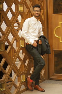 Portrait of young man standing in corridor