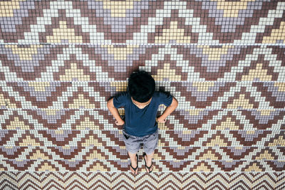 High angle view of boy lying on steps outdoors